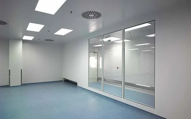 Empty cleanroom with glass partitions and ceiling-integrated LED luminaires.