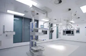 Modern hospital operating theatre with cleanroom lighting and medical equipment.